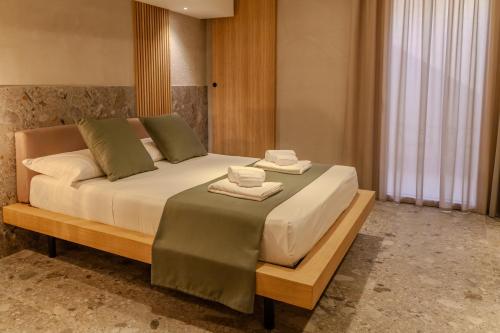 a bedroom with a large bed with towels on it at Residenza San Giovannello in Marsala