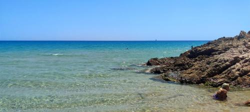 a person standing in the water at the beach at Quiet Home in Pula