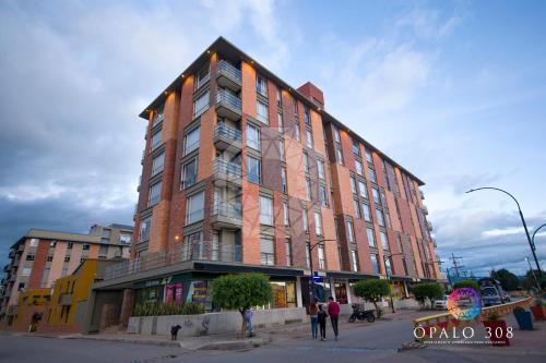 a large red brick building on a city street at Apartamento Ópalo 308 in Paipa
