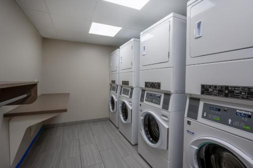 a laundry room with multiple washers and dryers at Staybridge Suites - Gilbert - East Mesa by IHG in Gilbert