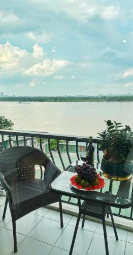 a plate of fruit on a table on a balcony at Sunrise Hanoi Hotel in Hanoi