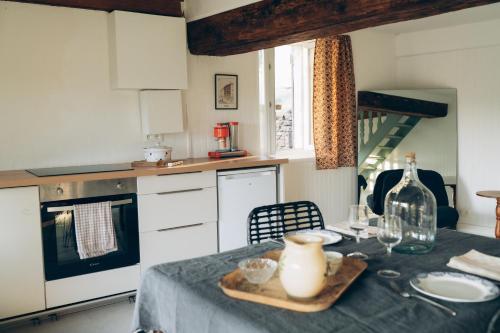 a kitchen with a table with a table cloth on it at Cottage en vignoble in Leynes