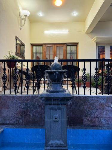 a water fountain in front of a balcony at ELIVAAS 3 BHK with Entertainment lounge - The Meadow in Nainital