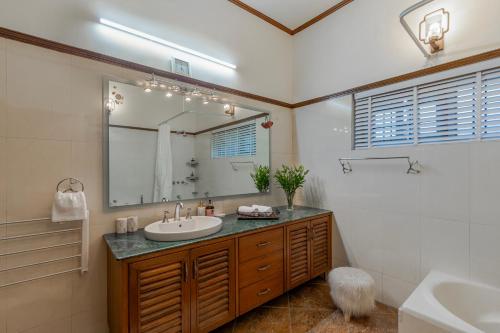 a bathroom with a sink and a mirror at ELIVAAS 3 BHK with Entertainment lounge - The Meadow in Nainital