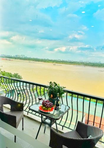 a table on a balcony with a view of the beach at Sunrise Hanoi Hotel in Hanoi