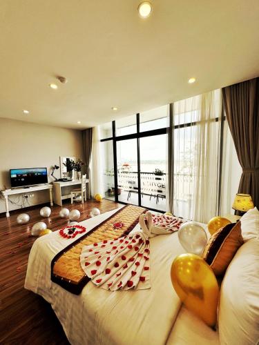 a hotel room with a large bed with food on it at Sunrise Hanoi Hotel in Hanoi