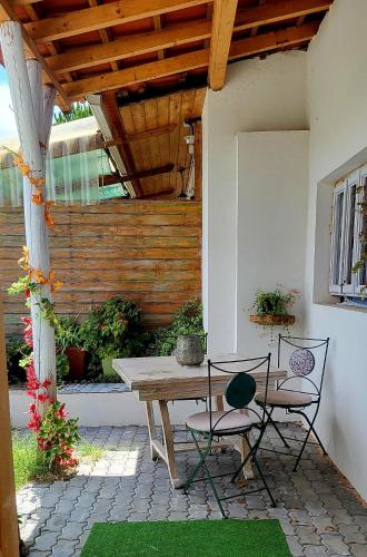 a patio with a wooden table and two chairs at Quinta da Choupana in Tomar