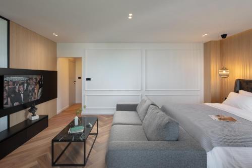 a living room with a couch and a tv at Canova Apartment in Labin