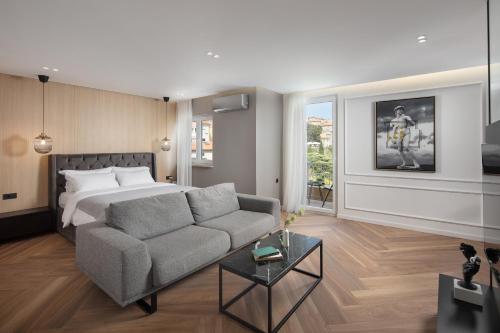 a living room with a bed and a couch at Canova Apartment in Labin
