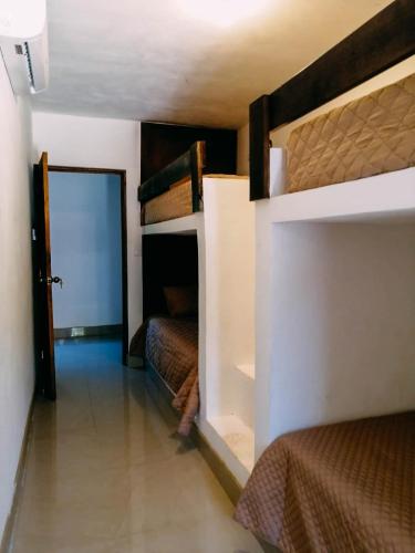 a bedroom with two bunk beds and a doorway at Stanza di Mare in Hawaii