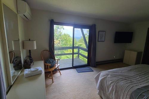 a bedroom with a bed and a sliding glass door at Pocono Mountain Village at Camelback 294 Overlook Way in Tannersville