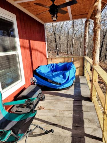 a covered porch with a blue tarp on a house at The Windstorm Cabin - Pet-friendly & a 2-person Jacuzzi hot tub! in Marshall