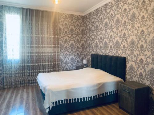 Llit o llits en una habitació de Uplistsikhe guest "Paluma"