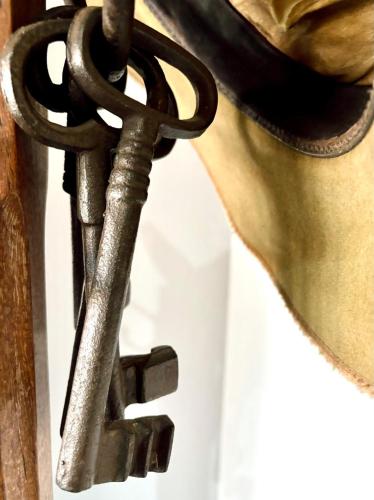 a woman is holding a metal door latch at Milkwood Safari Lodge in Warmbaths
