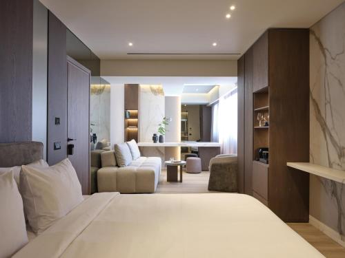 a bedroom with a bed and a living room at Nur Edge Aparthotel - Acropolis Skyline in Athens