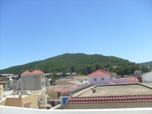 a view of a town with a mountain in the background at Résidence Choco in Tabarka