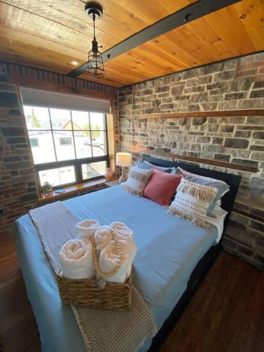 a bedroom with a bed with towels on it at The Lofts #3 - Cozy downtown studio getaway in Kingston