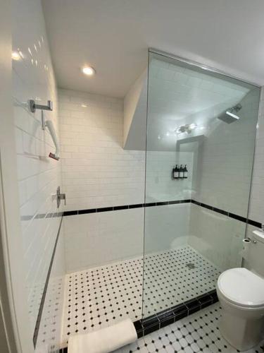 a bathroom with a shower and a toilet at The Lofts #3 - Cozy downtown studio getaway in Kingston