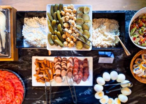 a buffet with different types of food on display at Nobilton Hotel in Kraków
