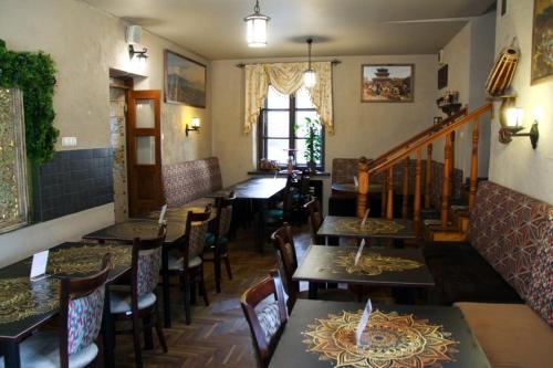 a restaurant with tables and chairs in a room at Nobilton Hotel in Kraków