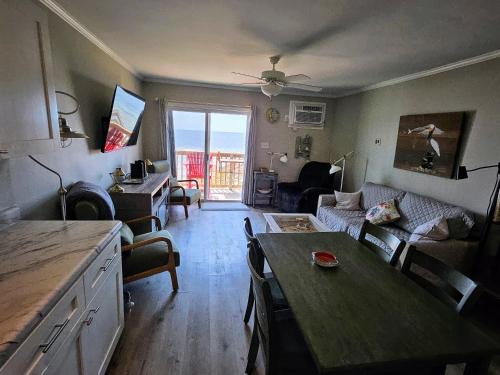 a living room with a couch and a table at Beachfront Bungalow 125 in North Topsail Beach