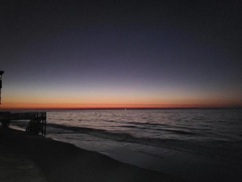 a view of the ocean at sunset at Beachfront Bungalow 125 in North Topsail Beach
