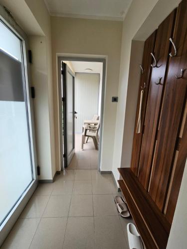 a hallway with a door and a chair in a room at Prenoćište Lana 2 in Novi Banovci