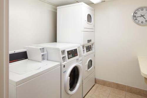a white laundry room with a washer and dryer at Residence Inn Arlington Rosslyn in Arlington