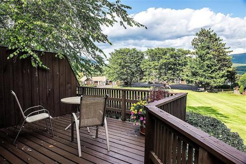 a wooden deck with a table and chairs on it at Manchester View in Manchester