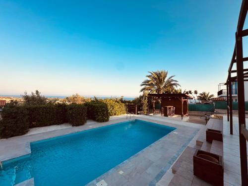 a swimming pool in the middle of a yard at House in Maroni in Pervolia
