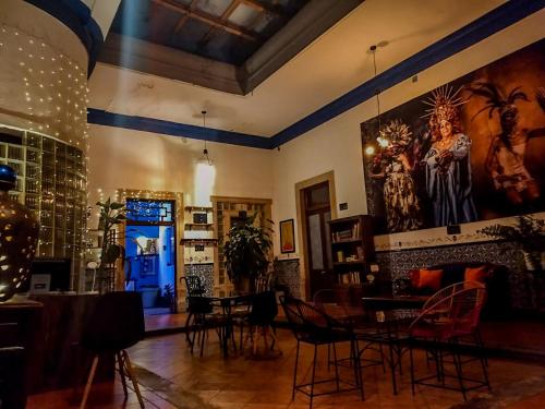 a room with chairs and a table and a painting on the wall at Villa Catrina in Morelia