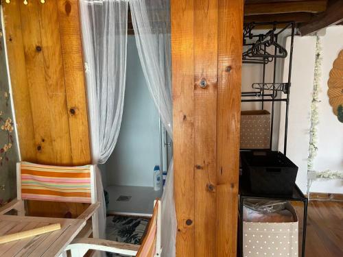 a room with a wooden door with a curtain at La Carmencita in Cedeira