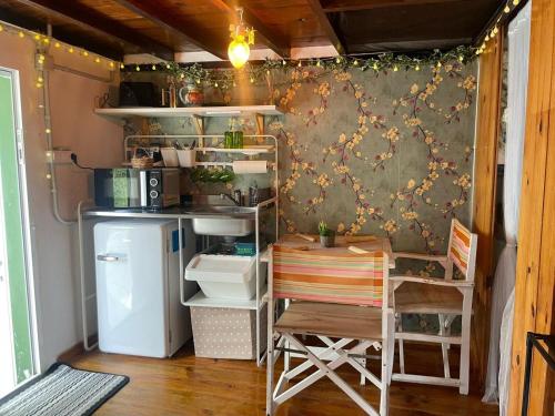 a small kitchen with a table and a refrigerator at La Carmencita in Cedeira