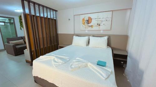 a bedroom with a bed with a towel on it at Flat FM20 Cabo Branco #L5 - By Almare in Tambaú