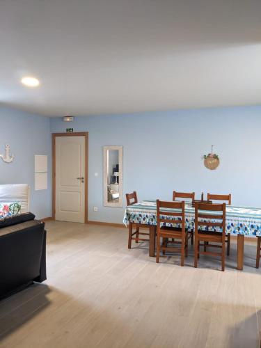 a living room with a dining room table and chairs at T2 na Praia da Costa Nova - Yellow Door in Costa Nova