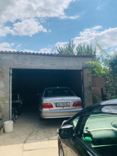 a car is parked inside of a garage at Uplistsikhe guest "Paluma" in Kʼvakhvreli
