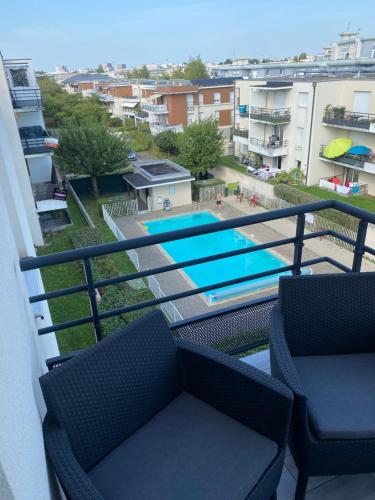 un balcon avec deux chaises et une piscine dans l'établissement Mg art, à Strasbourg