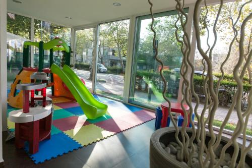 a childrens play area with a playground at Residence Sunrise Cesenatico in Cesenatico