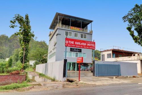 a building with a red sign in front of it at Super Collection O The Kailash Hotel in Dehradun