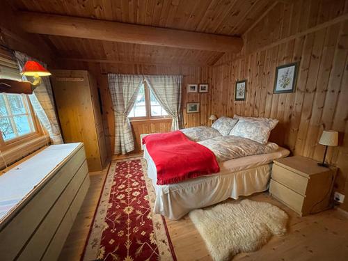 a bedroom with a bed in a wooden room at Mountain family cabin in Trysil