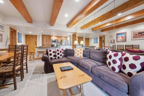 a living room with a couch and a table at Lodge at Lionshead 110-100 in Vail