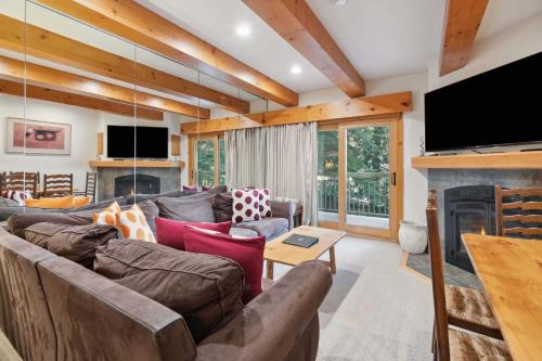 a living room with a couch and a fireplace at Lodge at Lionshead 110-100 in Vail