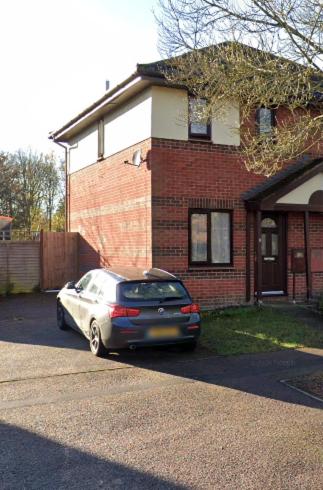a car parked in front of a brick house at Cozy 3-Bed House Near Willen Lake with Garden in Milton Keynes