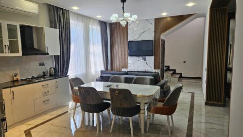a kitchen and dining room with a table and chairs at New Milan Mountain Ponoramic Hotel, with indoor heated swimming pool in Gabala