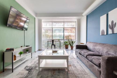 a living room with a couch and a table at Distrito Spencer 2 BR apartment in Polanco in Mexico City