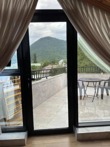 a view from a window of a patio with a table at New Milan Mountain Ponoramic Hotel, with indoor heated swimming pool in Gabala