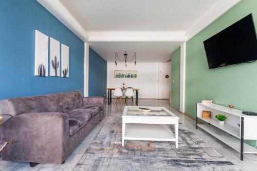a living room with a couch and a table at Distrito Spencer 2 BR apartment in Polanco in Mexico City