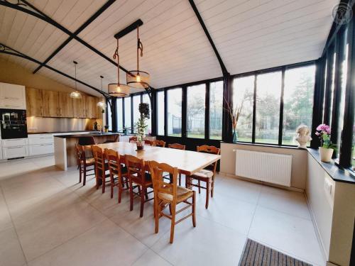 une cuisine et une salle à manger avec une table et des chaises dans l'établissement Maison de maître avec jardin, baby-foot, proche de Cassel et plages du Nord, tout inclus ! - FR-1-510-220, à Arnèke
