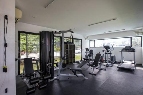 a gym with several treadmills and machines in a room at Peace of Mind - Las Brisas in Koolbaai