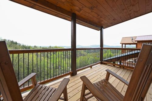 two chairs on the deck of a cabin at Fuzzy's Den in Pigeon Forge